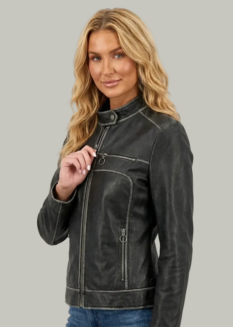 Woman wearing a black leather jacket and blue jeans on a white background