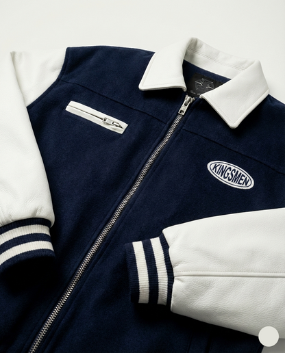 Navy and white jacket with 'Kingsmen' logo on a light gray background