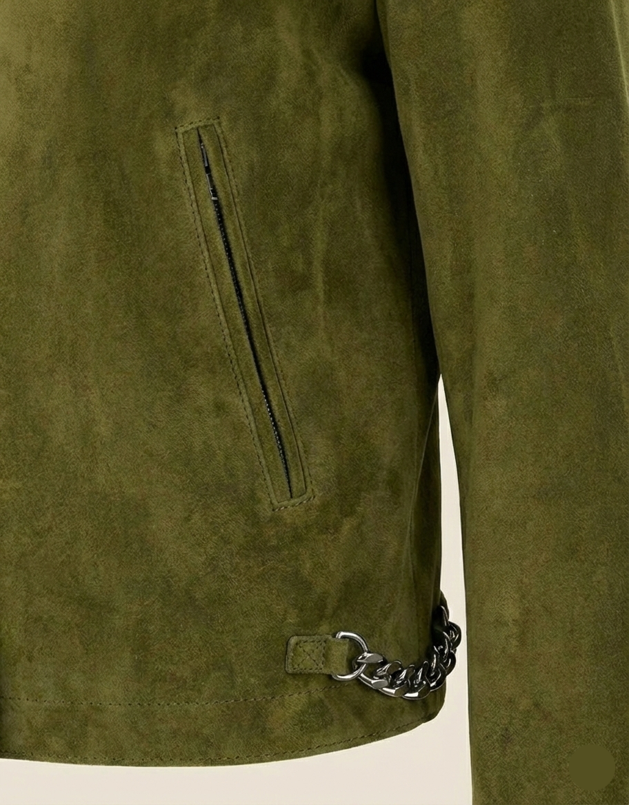 Close-up of a green suede jacket with a chain detail on a white background