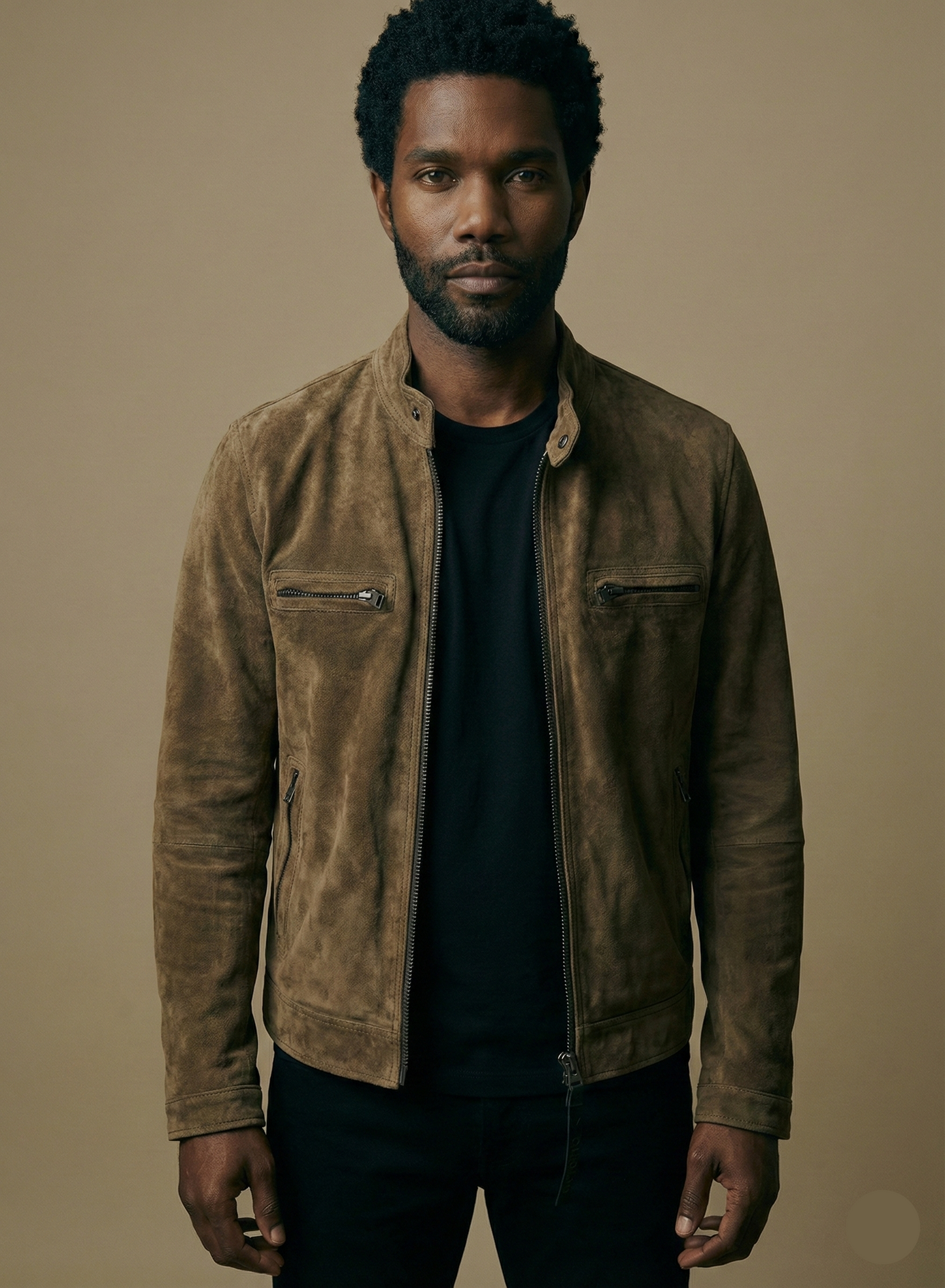 Man wearing a brown suede jacket against a beige background