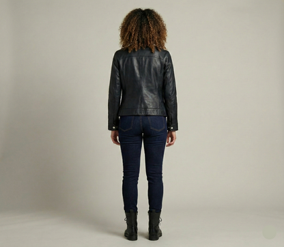 Person wearing a black leather jacket and dark jeans on a plain background