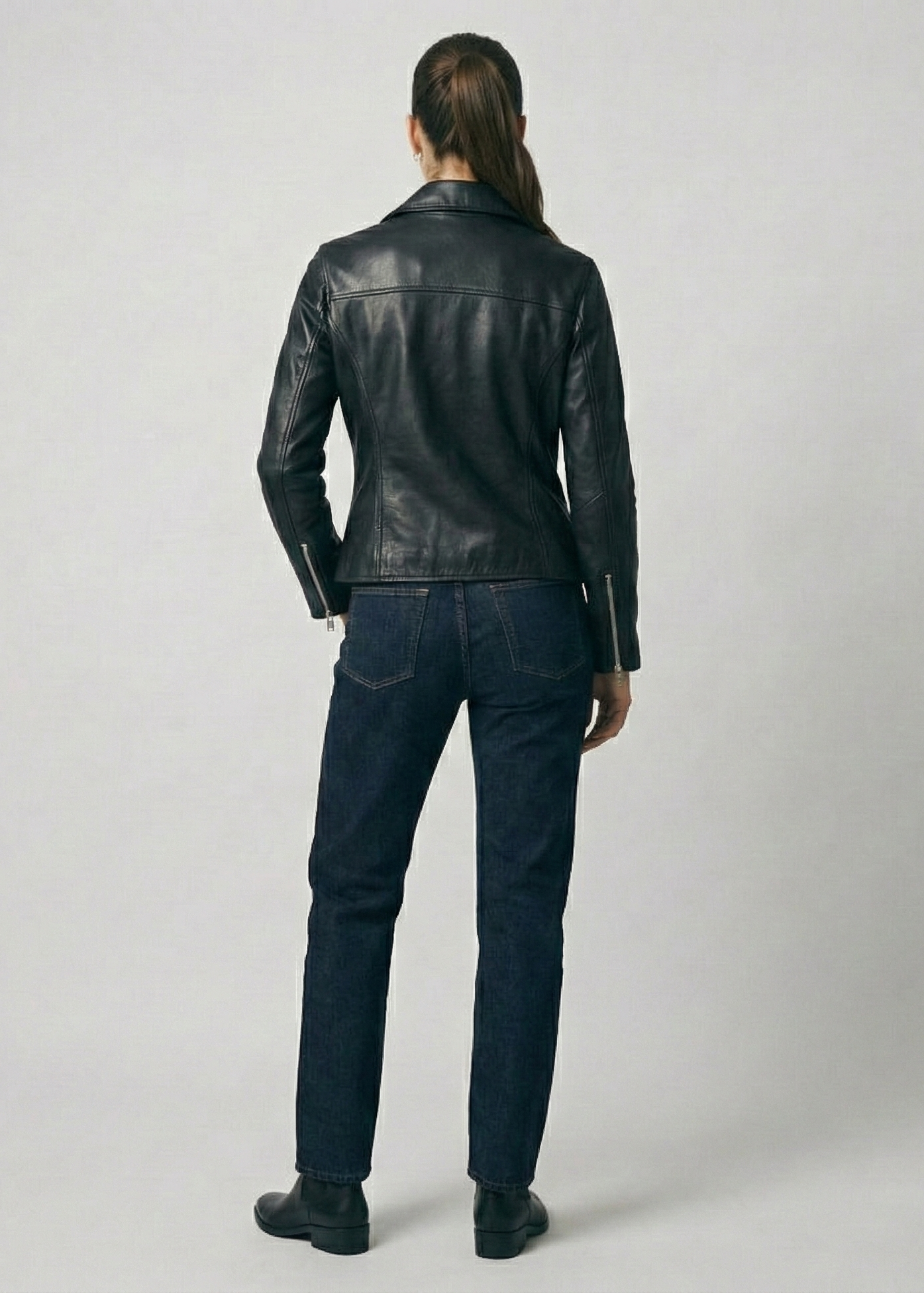 Women's black leather asymmetrical biker jacket with notched lapels and silver hardware by Kingsmen Couture