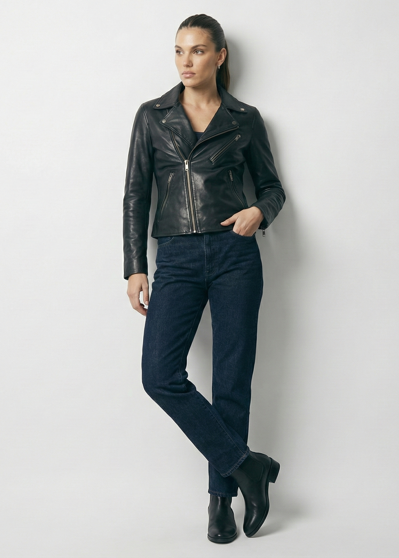 Women's black leather asymmetrical biker jacket with notched lapels and silver hardware by Kingsmen Couture