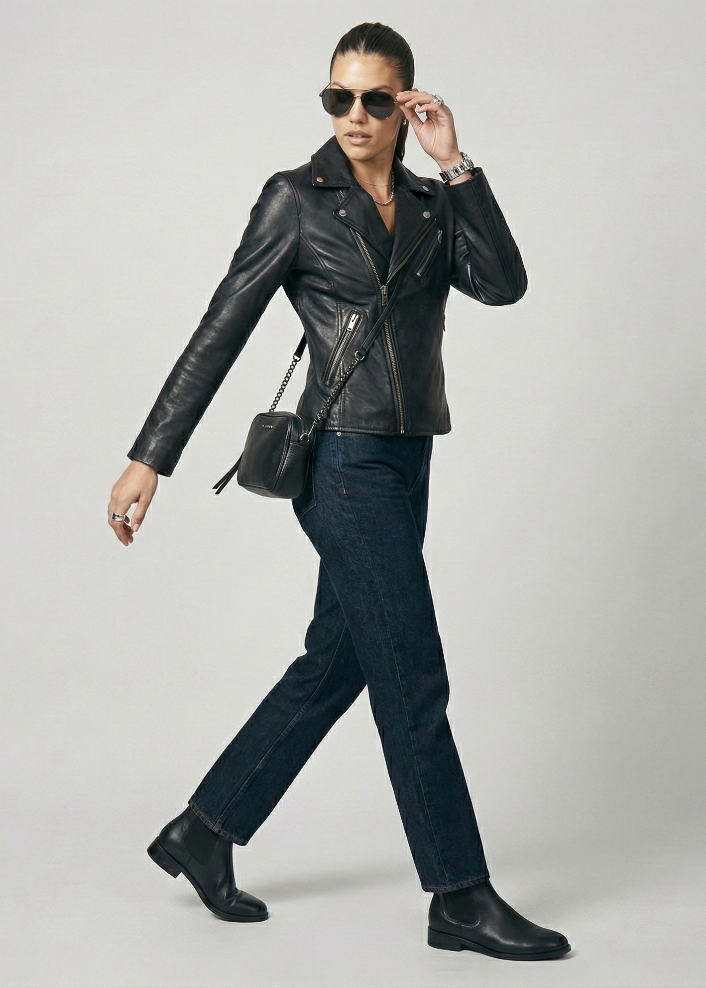 Women's black leather asymmetrical biker jacket with notched lapels and silver hardware by Kingsmen Couture.