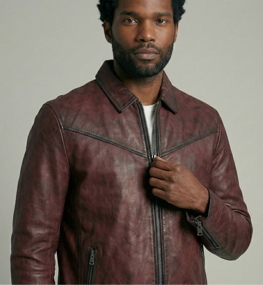 Man wearing a brown leather jacket against a plain background