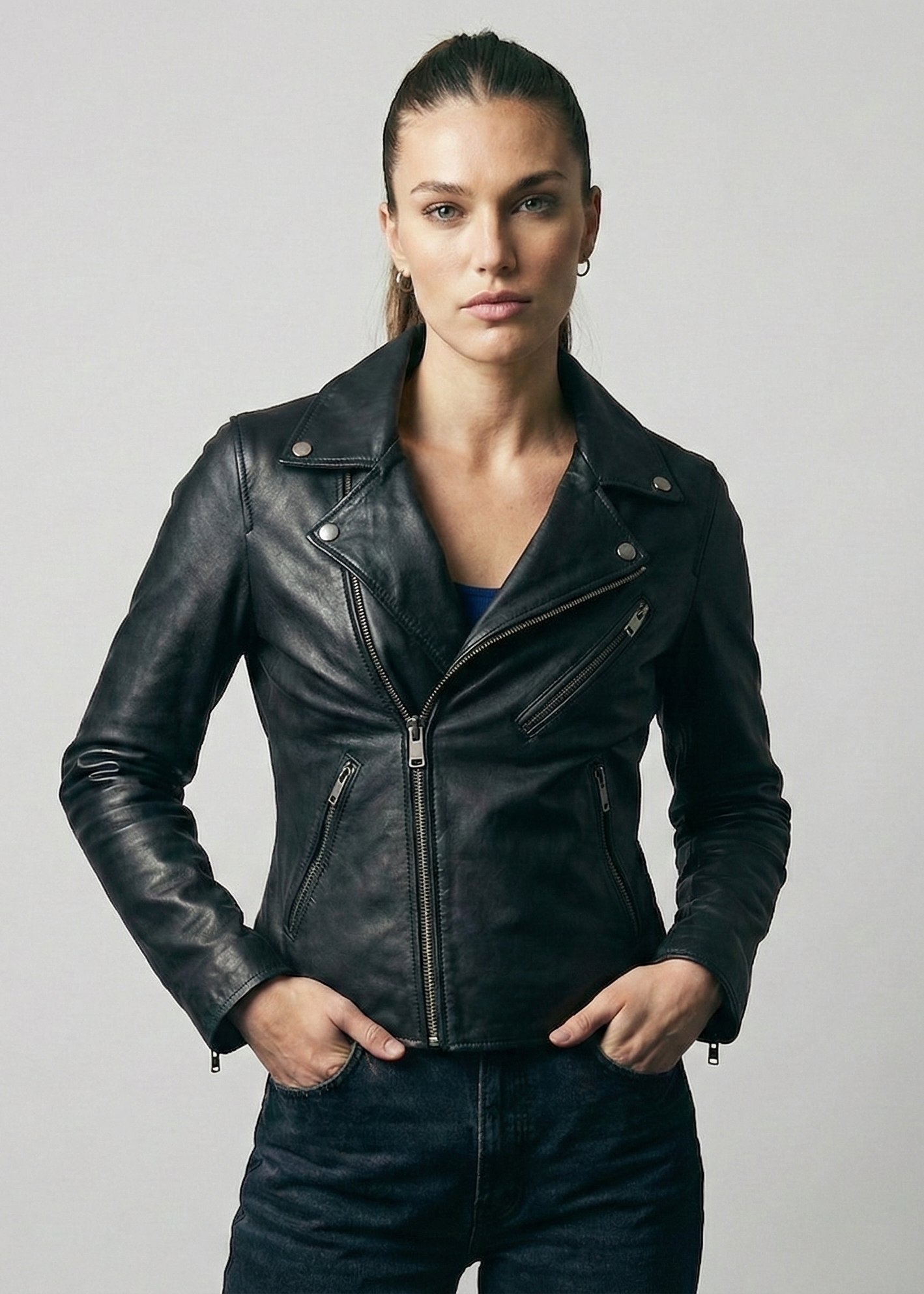 Women's black leather asymmetrical biker jacket with notched lapels and silver hardware by Kingsmen Couture.