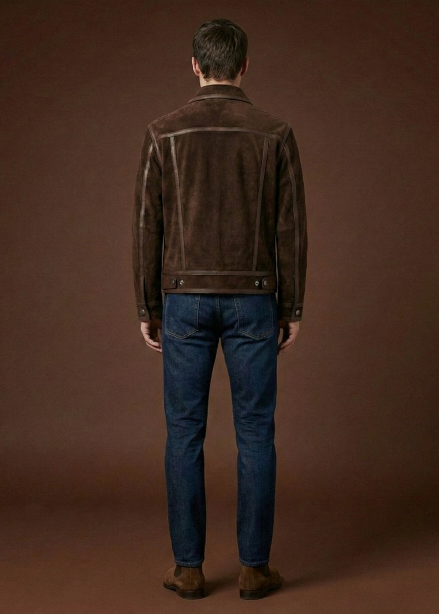 Men's dark brown sheepskin suede jacket featuring polished leather borders, silver hardware, and a pointed collar by Kingsmen Couture.