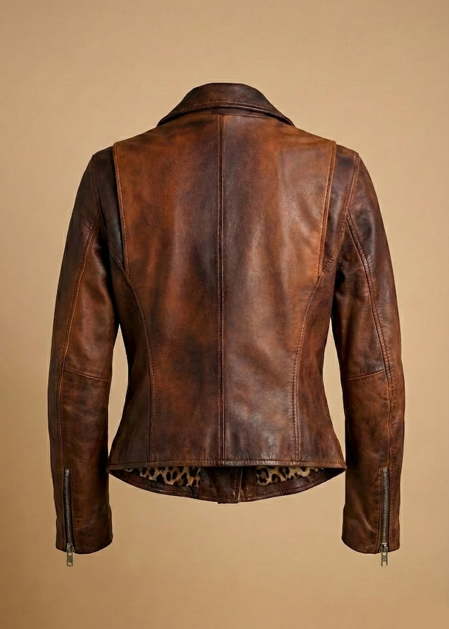 Women's distressed brown sheepskin leather biker jacket with silver hardware and animal print lining by Kingsmen Couture.