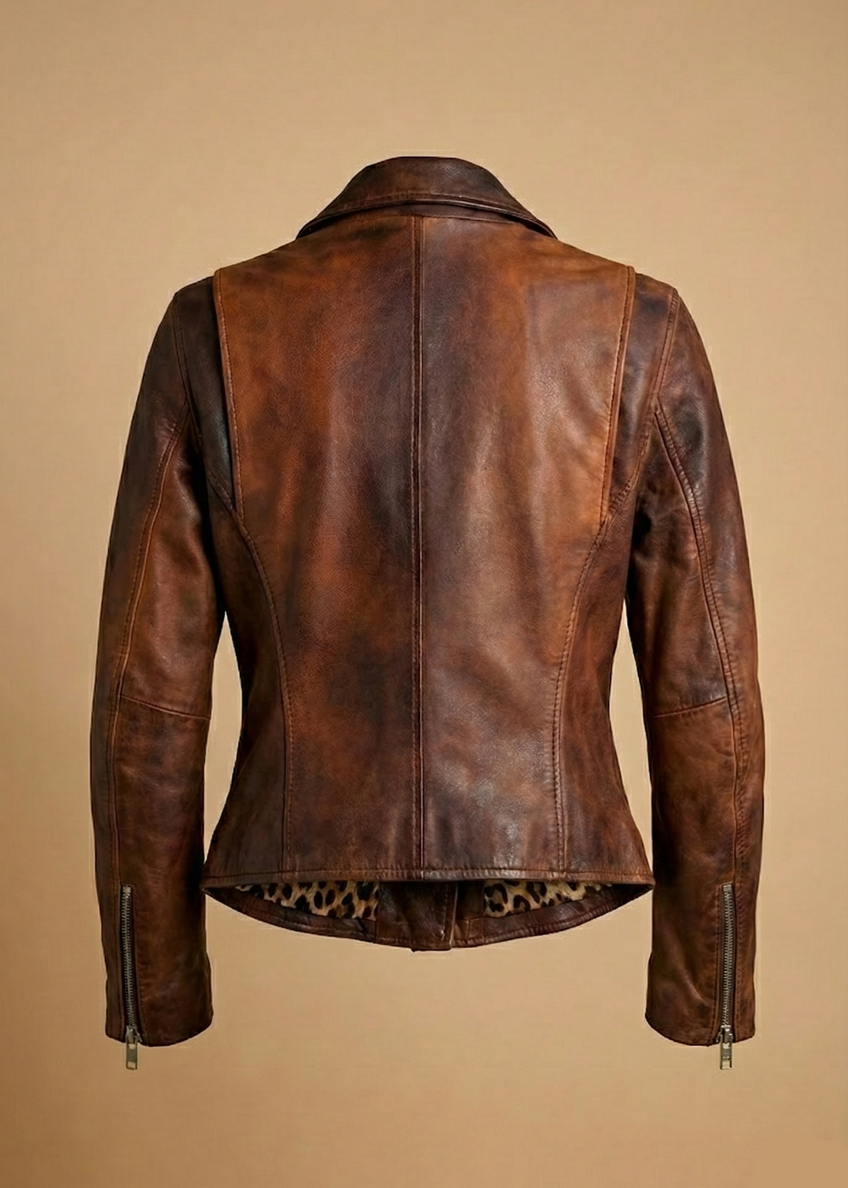 Women's distressed brown sheepskin leather biker jacket with silver hardware and animal print lining by Kingsmen Couture.